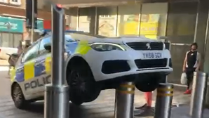 Police car gets stuck on bollard