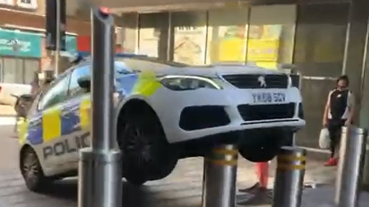 Police car gets stuck on bollard