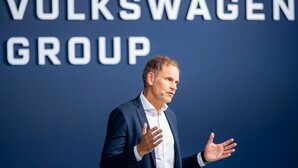 VW revises profit down